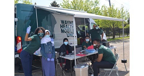 Image of Wayne Health Mobile Unit workers helping the community