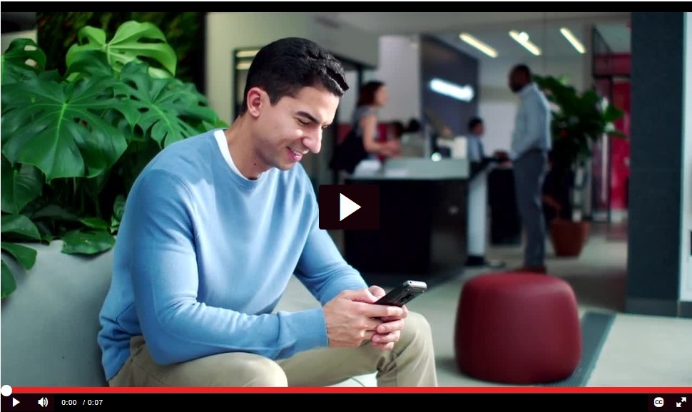 B-Roll clip of young man sitting while texting on mobile phone