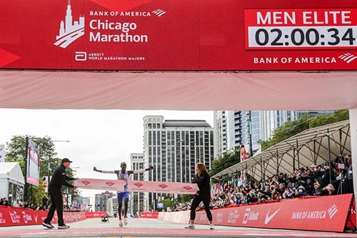 Kelvin Kiptum breaking the finish line tape and the world record at the 2023 Chicago Marathon