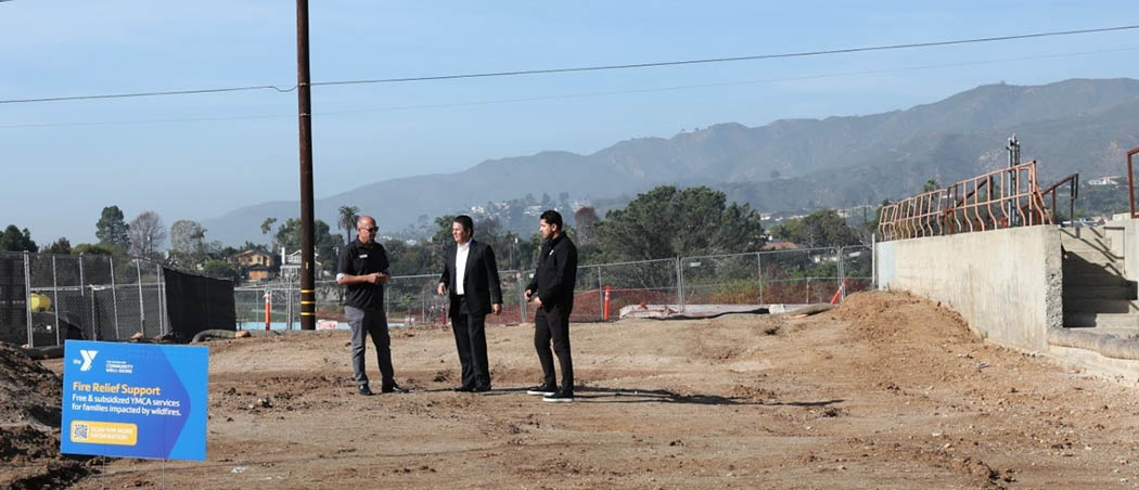 Photo of Jim Kirtley, Executive Director at Lowe Family YMCA, formerly Palisades-Malibu YMCA, left, talks with BofA's Raul Anaya and Mario Valenzuela of the YMCA of Metro Los Angeles at the site of the burned club